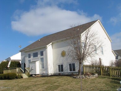Exterior back shows deck and fenced yard