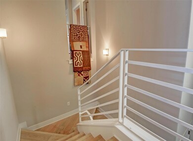 Staircase with wood finished floors and baseboards