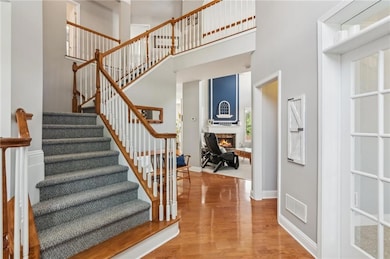 Staircase with a towering ceiling, wood finished f