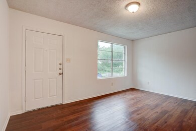 Empty room featuring dark wood finished floors, a