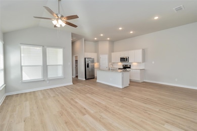Kitchen with open floor plan, visible vents, a si