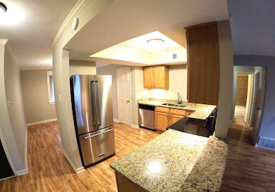 Kitchen featuring baseboards, appliances with stai