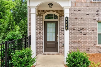 Doorway to property featuring brick siding