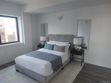 Bedroom with wood finished floors and baseboards