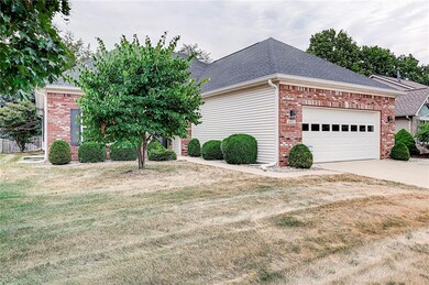 FRONT ELEVATION OF HOME WITH NICE RED BUD TREE