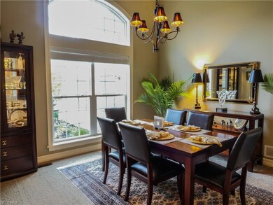 The carpeted formal dining area floods in natural 