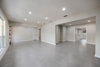 Unfurnished room featuring recessed lighting and baseboards