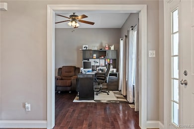 Office space featuring dark hardwood / wood-style