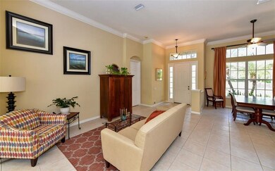 Living room with soaring ceilings and crown moldin