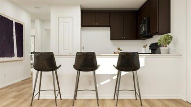 Kitchen featuring dark brown cabinetry and light h