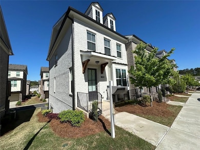 Townhome featuring brick siding