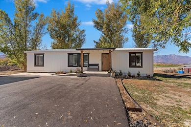 View of front of house featuring a porch, a metal roof, and a mountain view