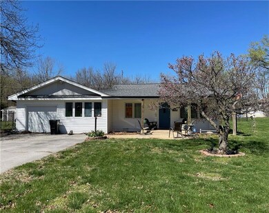 Ranch-style house featuring a front lawn and a garage