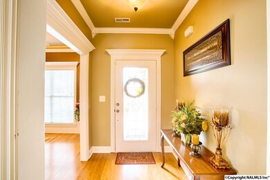 With hardwood flooring and crown molding.  The cased opening leads to the study.
