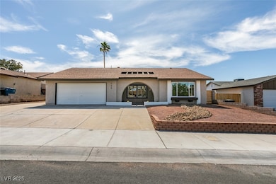 Ranch-style house featuring stucco siding, an atta