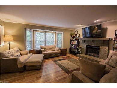 Family room with laminate floor and bow window.