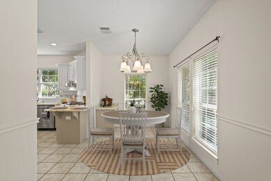 A bright & cheery breakfast room sits at the end o