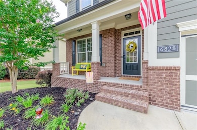 Property entrance with a porch and brick siding