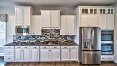 A walk in pantry, tile backsplash and a spacious i