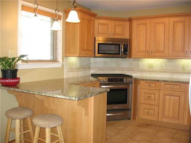 Kitchen. Granite and stainless KitchenAid applianc