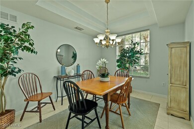 Dining space with a tray ceiling, light tile patte