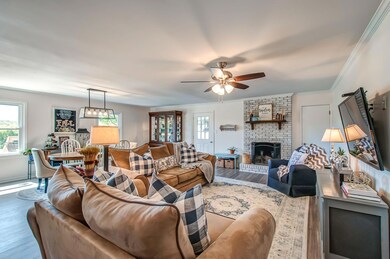 Totally open concept living/dining/kitchen area with new drywall, hardwood flooring and lighting