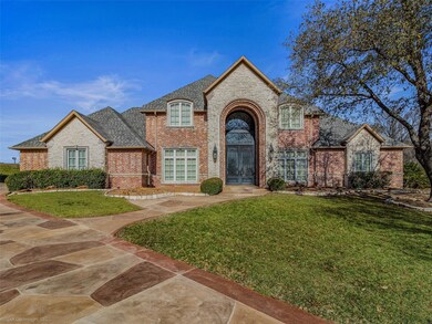 French country style house with a front lawn, bric
