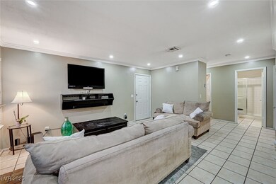 Living area with light tile patterned floors, visi