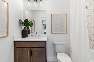 Full bathroom attached to bedroom on ground floor. Pictures are of model home