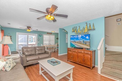 Living room with a textured ceiling, ceiling fan, 