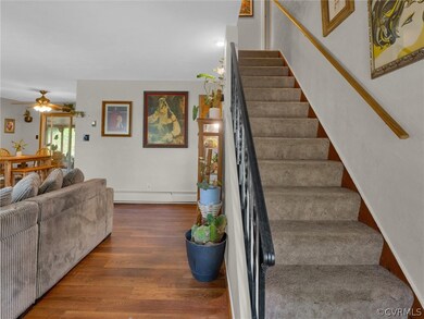 Stairs featuring ceiling fan, hardwood / wood-styl