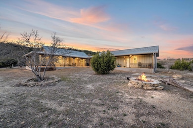 View of front facade with an outdoor fire pit, me
