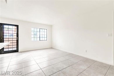 Spare room with light tile patterned flooring and