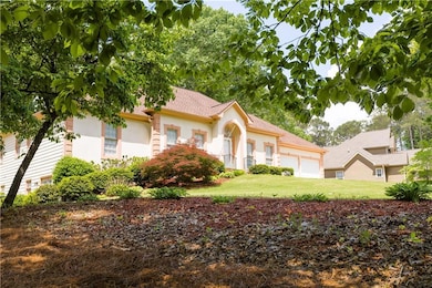 View of front of property featuring a garage, stuc