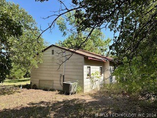View of side of home and air conditioner unit