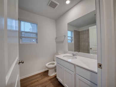 Bathroom featuring visible vents, wood finished f