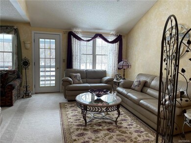Living room area opens to covered balcony overlook