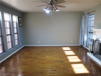An inviting living room has elegant flooring, tons