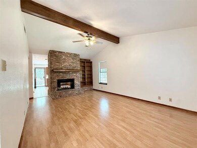 Unfurnished living room featuring ceiling fan, li