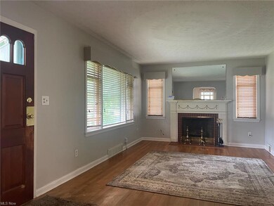 Unfurnished living room with hardwood floors and a