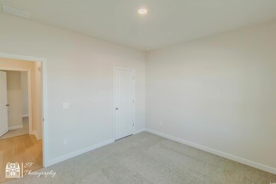 Unfurnished bedroom featuring light carpet