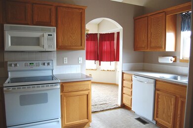 Oak cabinets, laminate countertops, tile backsplas