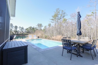 View of pool with a fenced in pool, outdoor dining area, a patio area, and fence