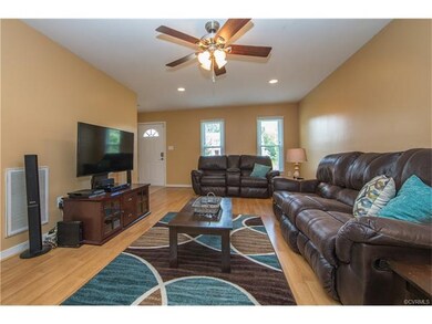 Great room with laminate floor and ceiling fan