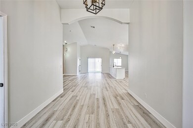 Unfurnished living room featuring arched walkways,