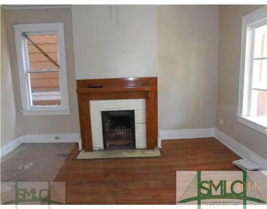 Other. Living room.  Note original fireplace and h