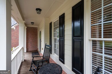 Cozy front porch with space for rocking chairs - perfect for relaxing.