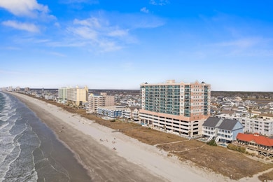 Drone / aerial view with a view of city, a beach v
