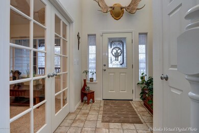 Entry, French doors to den