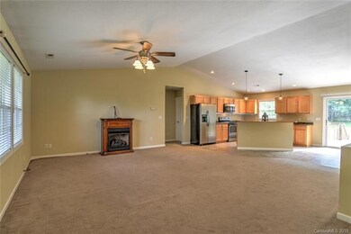 The open floor plan features gas fireplace, ceilin